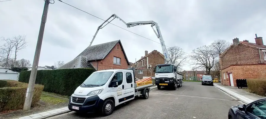 Camion-pompe et camionnette dans la rue devant la maison