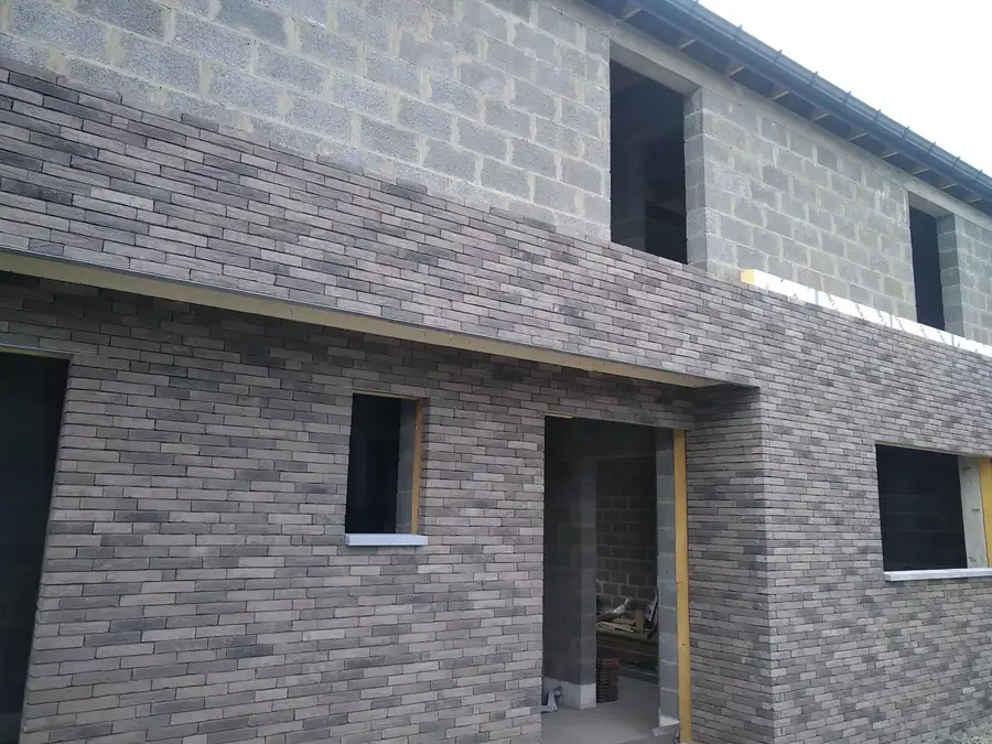 Façade en briques avec ouvertures de fenêtres