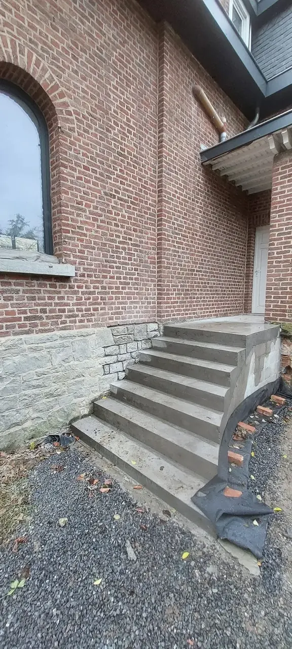 Escalier extérieur en pierre devant la façade en briques