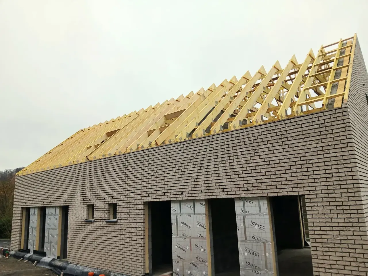 Maisons jumelées en briques avec charpente en bois posée